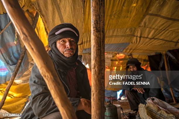 Amazigh man Moha Ouchaali sits in his tent near the village of Amellagou where Morocco's last nomads reside, on September 2, 2022. - In the...