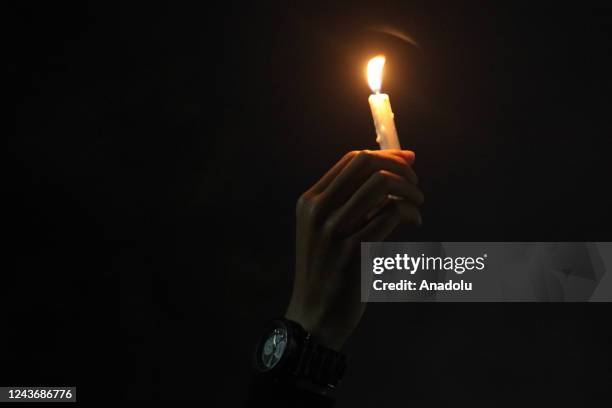 Residents and supporters of the Arema Malang FC light candles and pray together at the Gajayana Stadium, Malang, East Java, Indonesia on October 2,...