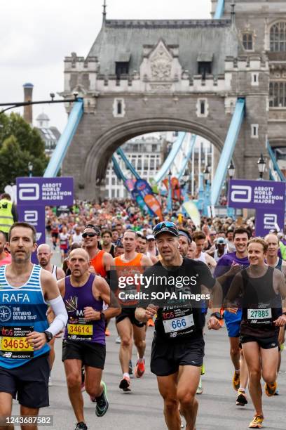 Participants of TCS 2022 London Marathon run along the Tower Bridge in central London. Nearly 42,000 runners participated in the 2022 London Marathon.