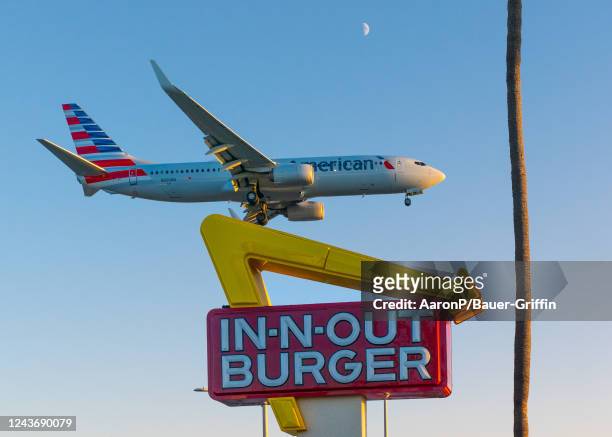 American Airlines Boeing 737-823 arrives at Los Angeles international Airport, flying past In-N-Out Burger on its final approach on October 02, 2022...