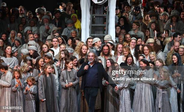 Dpatop - 02 October 2022, Bavaria, Oberammergau: Christian Stückl, director of the Passion Play, stands on stage with the participants after the end...