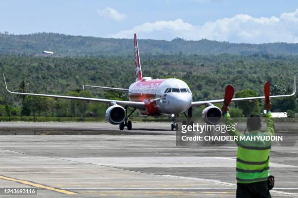 An AirAsia passenger plane lands from Malaysia for the first time since the route was reopened after being suspended for almost three years due to...