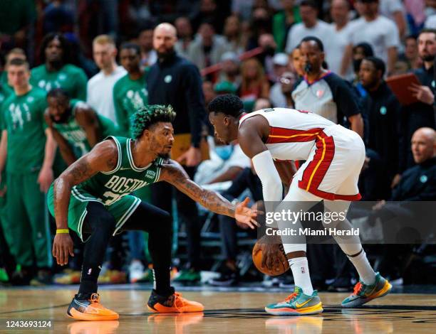 Miami Heat guard Victor Oladipo drives against Boston Celtics guard Marcus Smart during the first quarter of Game Seven of the NBA Eastern Conference...