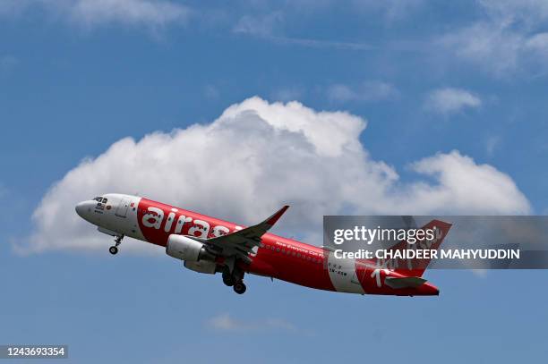 An AirAsia passenger plane takes for Malaysia for the first time since the route was reopened after being suspended for almost three years due to the...