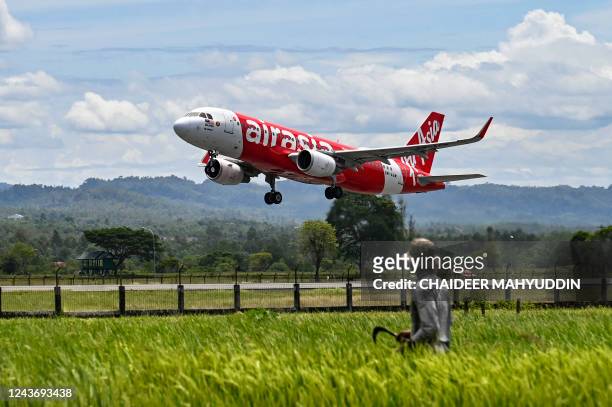 An AirAsia passenger plane takes for Malaysia for the first time since the route was reopened after being suspended for almost three years due to the...