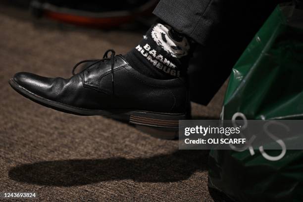 Delegate's socks, reading 'Baahh Humbug!" - a reference connected with author Charles Dickens' character Ebenezer Scrooge in A Christmas Carol - are...