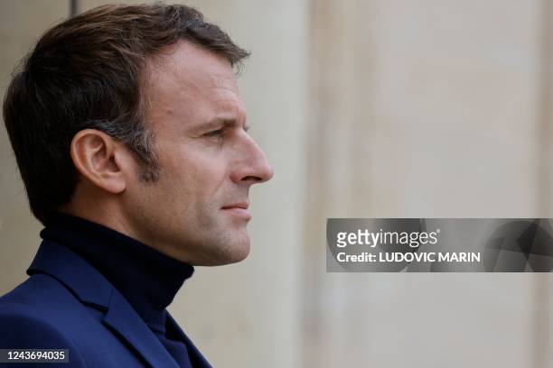 French President Emmanuel Macron, wearing a turtleneck jumper, welcomes Guinea-Bissau's President at the Elysee Palace in Paris, on October 3, 2022.