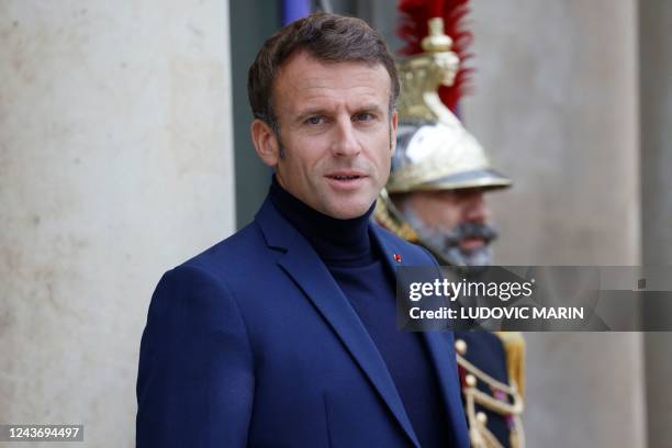 French President Emmanuel Macron, wearing a turtleneck jumper, welcomes Guinea-Bissau's President at the Elysee Palace in Paris, on October 3, 2022.