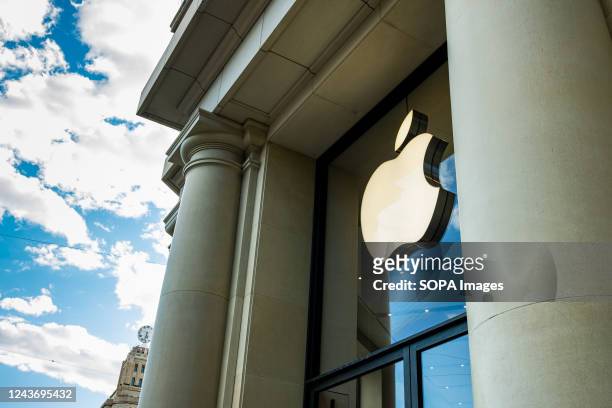 The consumer technology company Apple logo is seen at the entrance of an Apple store.