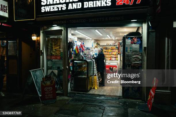 Customer at the counter of a general store in the Soho district of central London, UK, on Friday, Sept. 30, 2022. UK retailers are facing a mortgage...