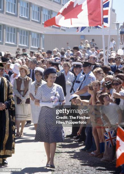 Queen Elizabeth II greeting the crowd lining the streets of St. John's as she arrives for a reception and luncheon at City Hall in Newfoundland,...