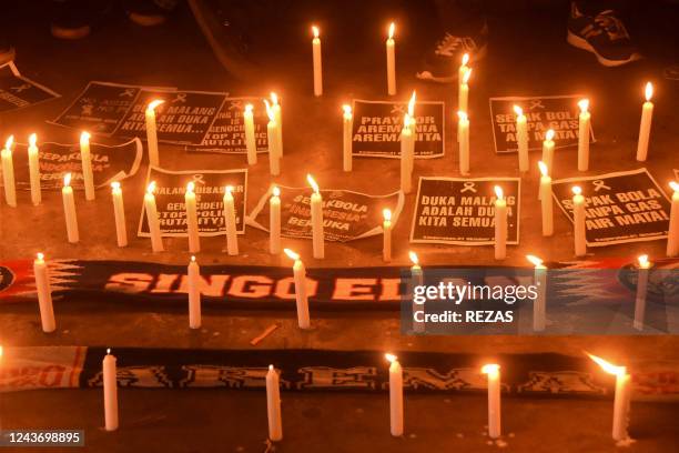 Football supporters hold candlelight vigil for victims of a stampede, in Bekasi on October 3, 2022. - Anger against police mounted in Indonesia on...
