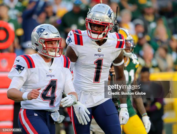Green Bay, WI New England Patriots quarterback Bailey Zappe celebrates with DeVante Parker after the pair teamed up on Zappes first NFL touchdown...