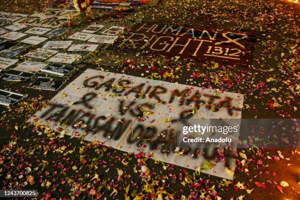 Football fans watch a candle flame shaped like a sign of love as condolences to the victims of the football match outside the Kanjuruhan Stadium in...