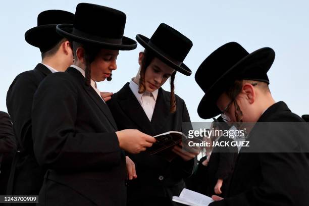 Ultra-Orthodox Jewish men and children perform the "Tashlich" ritual, during which "sins are cast into the water to the fish", ahead of the Day of...