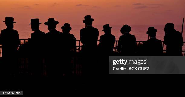 Ultra-Orthodox Jewish men and children perform the "Tashlich" ritual, during which "sins are cast into the water to the fish", ahead of the Day of...