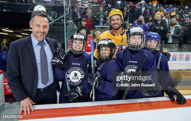 Roman Josi of the Nashville Predators poses with former NHL player Mark Streit and young girl hockey players as the NHLPA Goals & Dreams donated 25...