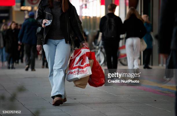 Woman holding shopping bags iss een walking in Warsaw, Poland on 03 October, 2022.