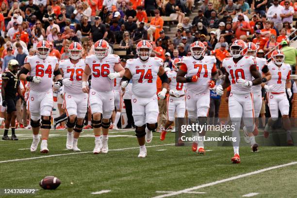 Players of the Clemson Tigers return to the field during their game against the Wake Forest Demon Deacons at Truist Field on September 24, 2022 in...