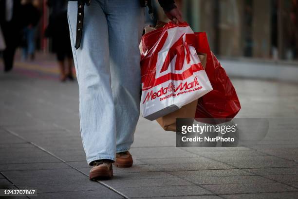 Woman holding shopping bags iss een walking in Warsaw, Poland on 03 October, 2022.