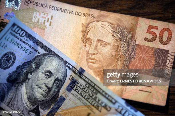 Image of US Dollars and Brazilian Reais bills in Sao Paulo, Brazil, on October 03, 2022. - Investors' optimism in Brazil drove the São Paulo stock...