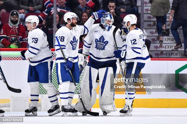 Brodie and Zach Aston-Reese of the Toronto Maple Leafs congratulate goaltender Matt Murray on a victory in a preseason game against the Montreal...