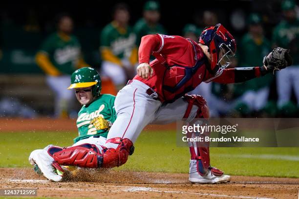 Nick Allen of the Oakland Athletics is out against catcher Logan O'Hoppe at home on a bases-loaded fielder's choice off the bat of Seth Brown in the...