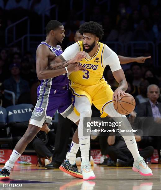 Anthony Davis of the Los Angeles Lakers is defended by De'Aaron Fox of the Sacramento Kings during the first half at Crypto.com Arena on October 3,...