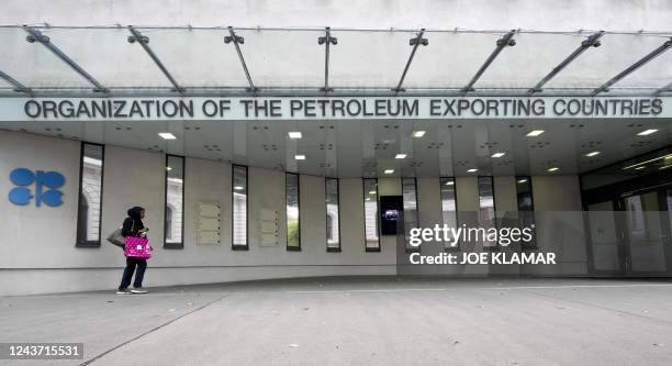 Woman walks past OPEC headquarters on October 4, 2022 on the eve of the 45th Meeting of the Joint Ministerial Monitoring Committee and the 33rd OPEC...