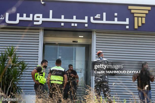 Members of Lebanon's security forces and emergency services deploy at a bank branch held-up by an angry depositor demanding access to his savings, in...