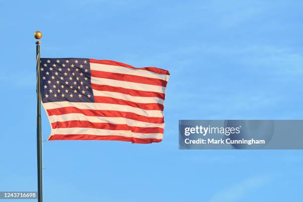 The American Flag flies from a flag pole during the Major League Baseball game between the Detroit Tigers and the Minnesota Twins at Comerica Park on...