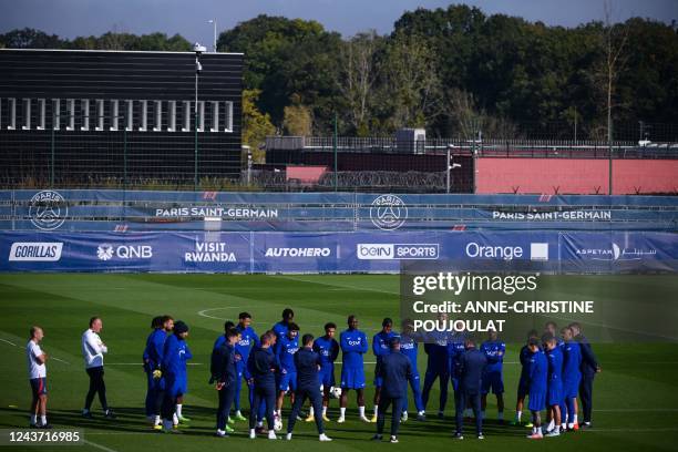 Paris Saint-Germain's players gather to listen to their coach during a training session at the club's Camp des Loges training ground in...