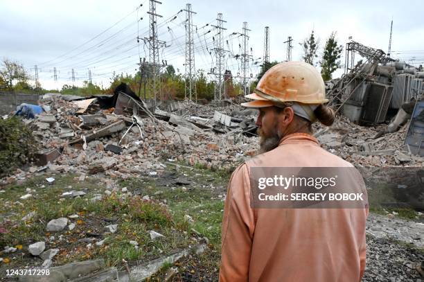 An employee of an energy company inspects an electrical transformer substation destroyed by Russian missiles strike outskirts of Khark?v, on October...