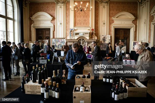 Bottles of wine are on display as visitors look at items, seized and confiscated as part of criminal proceedings, before they are auctioned at the...