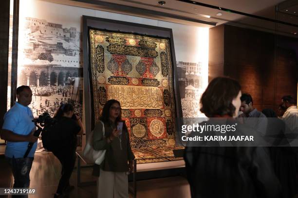 Visitors view a fragment of the Kiswa, the cloth used to cover the Kaaba at the Grand Mosque in the Muslim holy city of Mecca, dating to the Hijri...