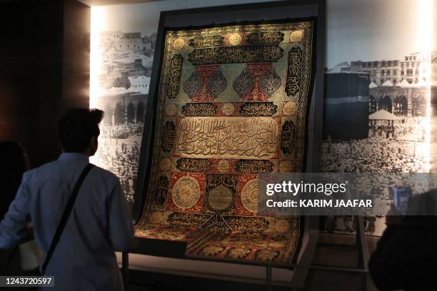 Visitor views a fragment of the Kiswa, the cloth used to cover the Kaaba at the Grand Mosque in the Muslim holy city of Mecca, dating to the Hijri...