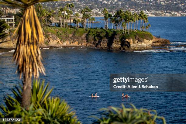 Laguna Beach, CA Paddle boarders take a scenic sunset cruise amidst warm weather in Crescent Bay Beach in Laguna Beach Monday, Oct. 3, 2022.