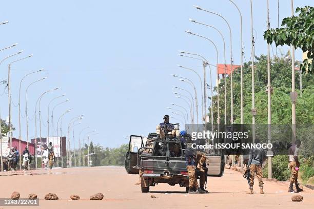 Burkina Faso soldiers man a checkpoint on the road leading to the Ouaga 2000 conference center on October 4, 2022 in Ouagadougou. - Several dozen...