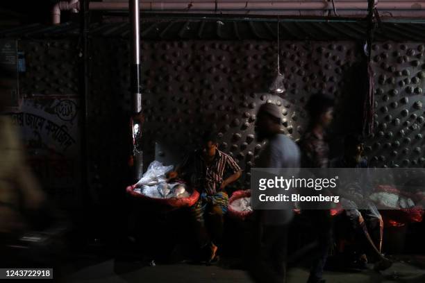 Street vendor waits for customers during the power outage in Dhaka, Bangladesh, on Tuesday, Oct. 4, 2022. Nearly half of Bangladesh was left without...
