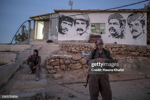 Female member of the Komala of Revolutionary Toilers of Iranian Kurdistan look at the sky after she heard a drone from their old base, which was...