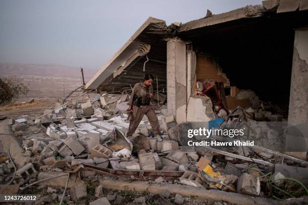 Female members of the Komala of Revolutionary Toilers of Iranian Kurdistan stand in their old base, which was destroyed after the Iranian drone...