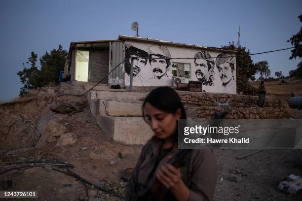 Female members of the Komala of Revolutionary Toilers of Iranian Kurdistan stand in their old base, which was destroyed after the Iranian drone...