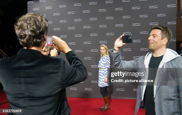 October 2022, Hamburg: Actress Petra Schmidt-Schaller , stands on the red carpet at the 30th Filmfest Hamburg at the Cinemaxx cinema for the...