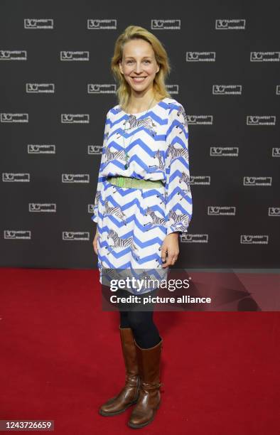 October 2022, Hamburg: Actress Petra Schmidt-Schaller stands on the red carpet at the 30th Filmfest Hamburg at the Cinemaxx cinema during the...