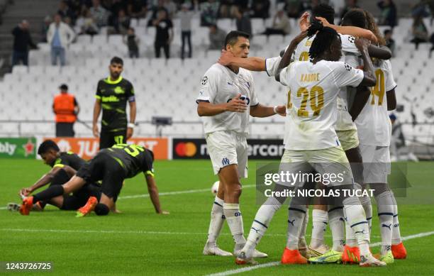 Marseille's players celebrate after scoring their team's fourth goal during the UEFA Champions League group D, football match between Olympique...