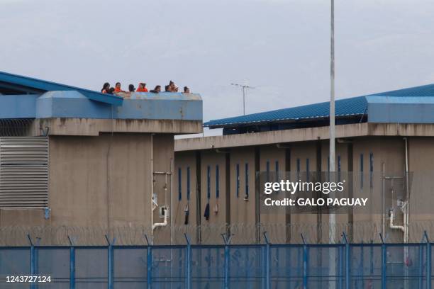 Female inmates stand on a roof after fresh clashes between prisoners were reported at the Regional Sierra Centro Norte Cotopaxi prison, in Latacunga,...