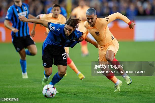 Club Brugge's Danish midfielder Casper Nielsen fights for the ball with Atletico Madrid's French forward Antoine Griezmann during the UEFA Champions...