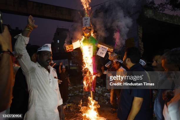 Leader Durgesh Pathak burns the effigy of Ravan in protest against the MCD in front of a pile of garbage at Inderpuri on October 4, 2022 in New...