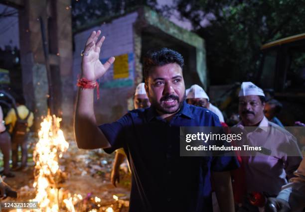 Leader Durgesh Pathak burns the effigy of Ravan in protest against the MCD in front of a pile of garbage at Inderpuri on October 4, 2022 in New...