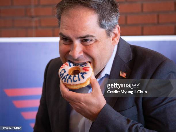 Congressman Mike Garcia bites into one of his namesake donuts made specially for his visit to California Bakery and Cafe in Santa Clarita on Tuesday,...